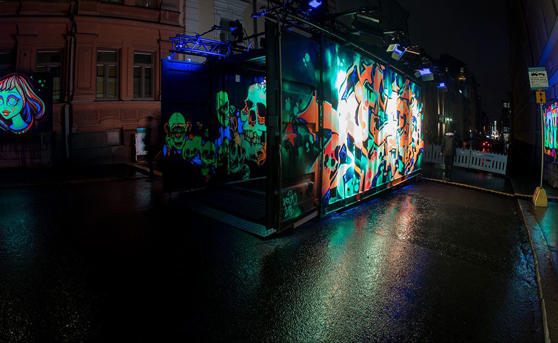 Sea container painted with neon paint, on display at the center of Helsinki.