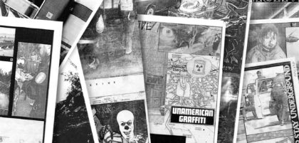 Black and white fanzines on a pile.
